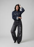 DAXUEN Distressed wide-leg denim pants with unique pockets and embroidery — model photo