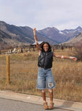 DAXUEN Distressed wide-leg denim shorts with rips — model photo