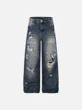 Vintage blue wide-leg denim jeans featuring heavy ripped distressing and bronze stud hardware