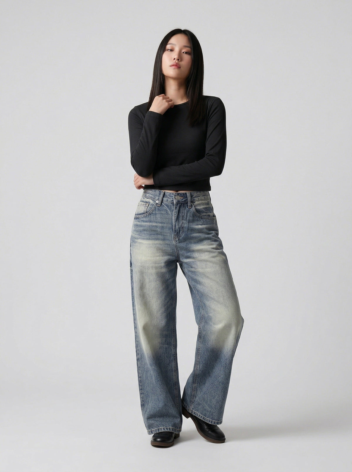 DAXUEN Distressed high-waisted wide-leg jeans in medium blue denim — model photo