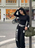 DAXUEN Distressed wide-leg sweatpants in black and grey — model photo