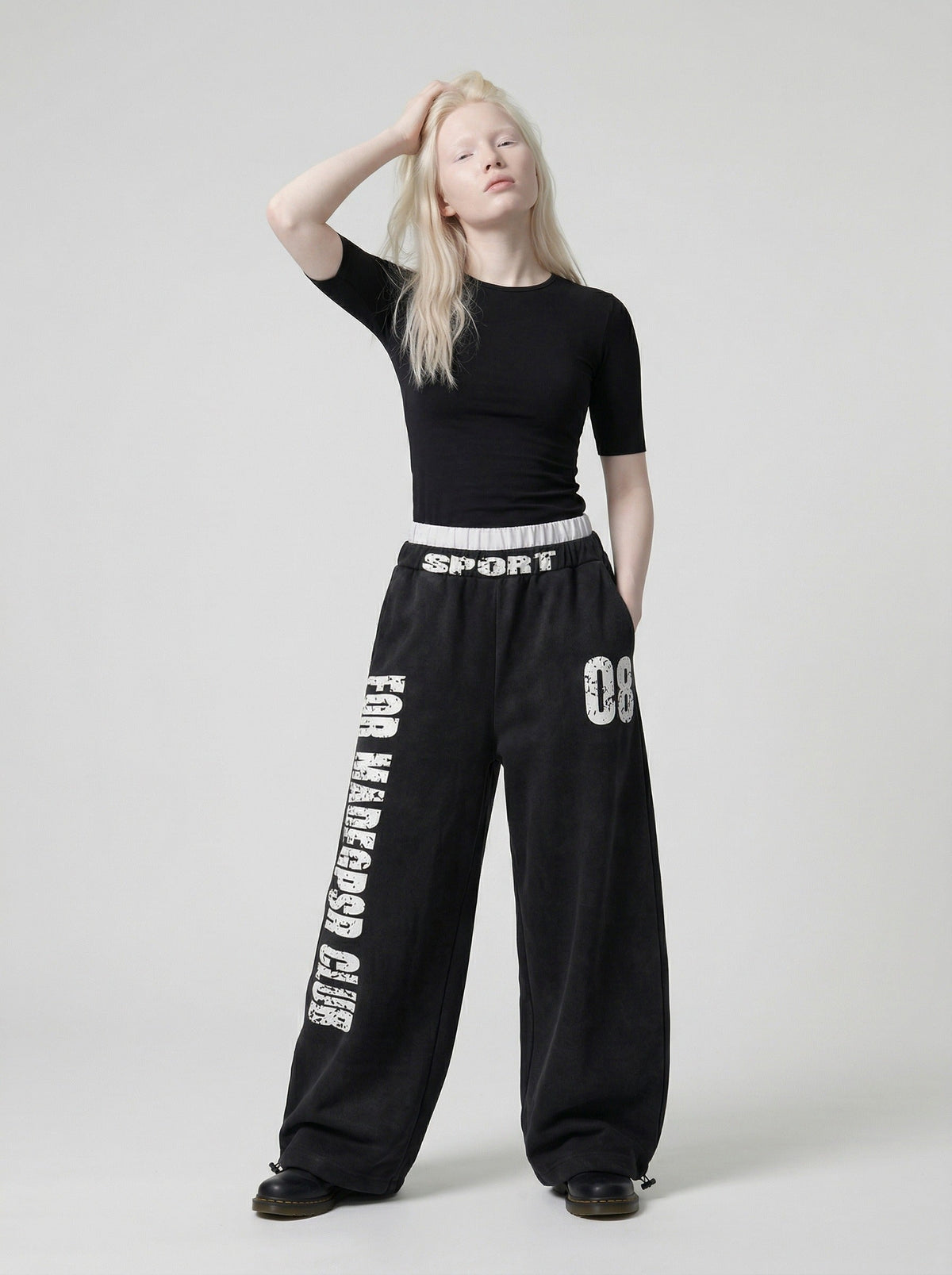 DAXUEN Distressed wide-leg sweatpants in black and grey — model photo