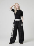 DAXUEN Distressed wide-leg sweatpants in black and grey — model photo