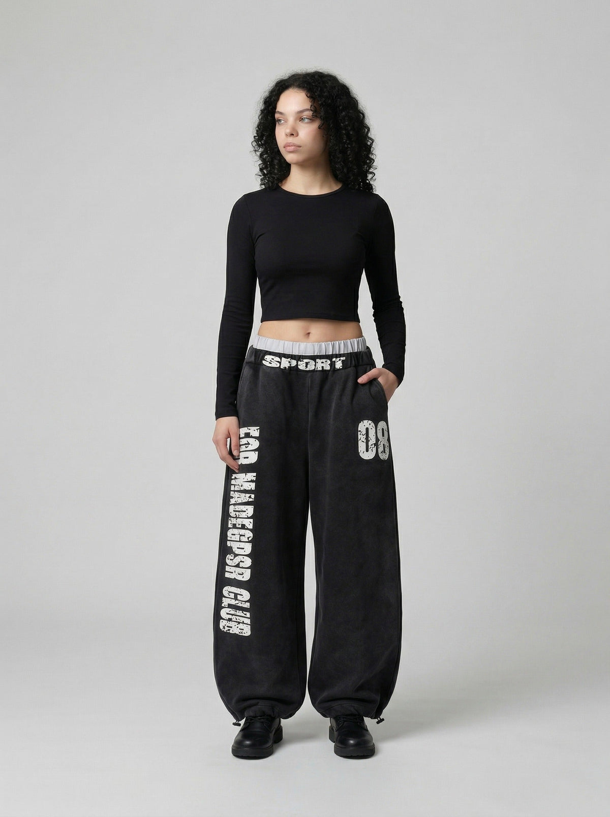 DAXUEN Distressed wide-leg sweatpants in black and grey — model photo