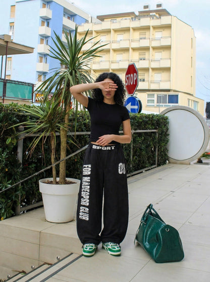 DAXUEN Distressed wide-leg sweatpants in black and grey — model photo