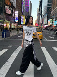 DAXUEN Draped asymmetrical women's t-shirt with graphic design — model photo