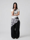 DAXUEN Draped asymmetrical women's t-shirt with graphic design — model photo