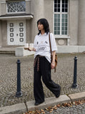 DAXUEN black oversized embroidered animal motif polo shirt — model photo