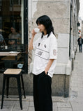 DAXUEN black oversized embroidered animal motif polo shirt — model photo