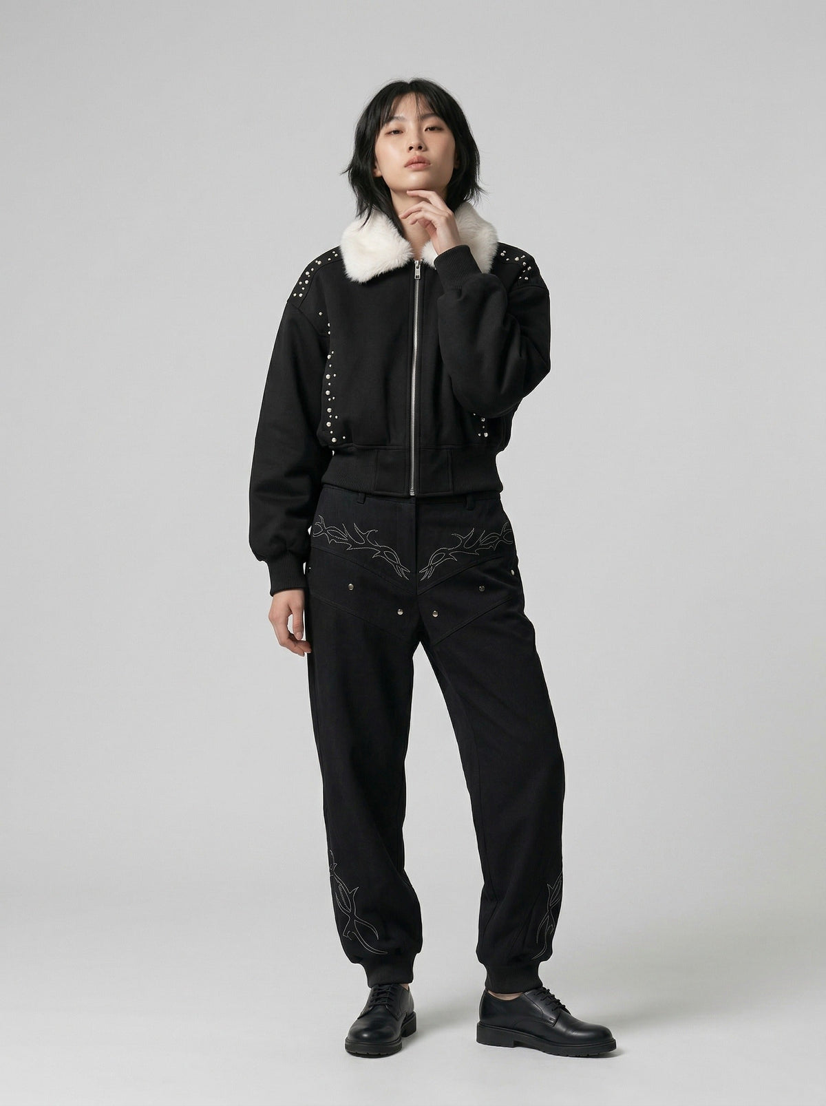 DAXUEN Embroidered bomber jacket in black and beige — model photo