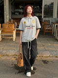 DAXUEN Embroidered graphic polo shirt in black and light grey marl — model photo