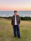 DAXUEN dark blue velvet embroidered script track pants — model photo