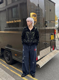 DAXUEN dark blue velvet embroidered script track pants — model photo
