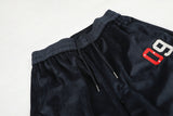 DAXUEN dark blue velvet embroidered script track pants
