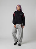 DAXUEN black embroidered shield logo track jacket — model photo
