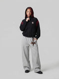 DAXUEN black embroidered shield logo track jacket — model photo