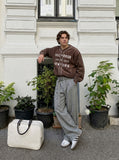 DAXUEN muted brown embroidered text corduroy baseball jacket — model photo