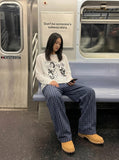 DAXUEN Graphic long sleeve t-shirt with text and designs — model photo