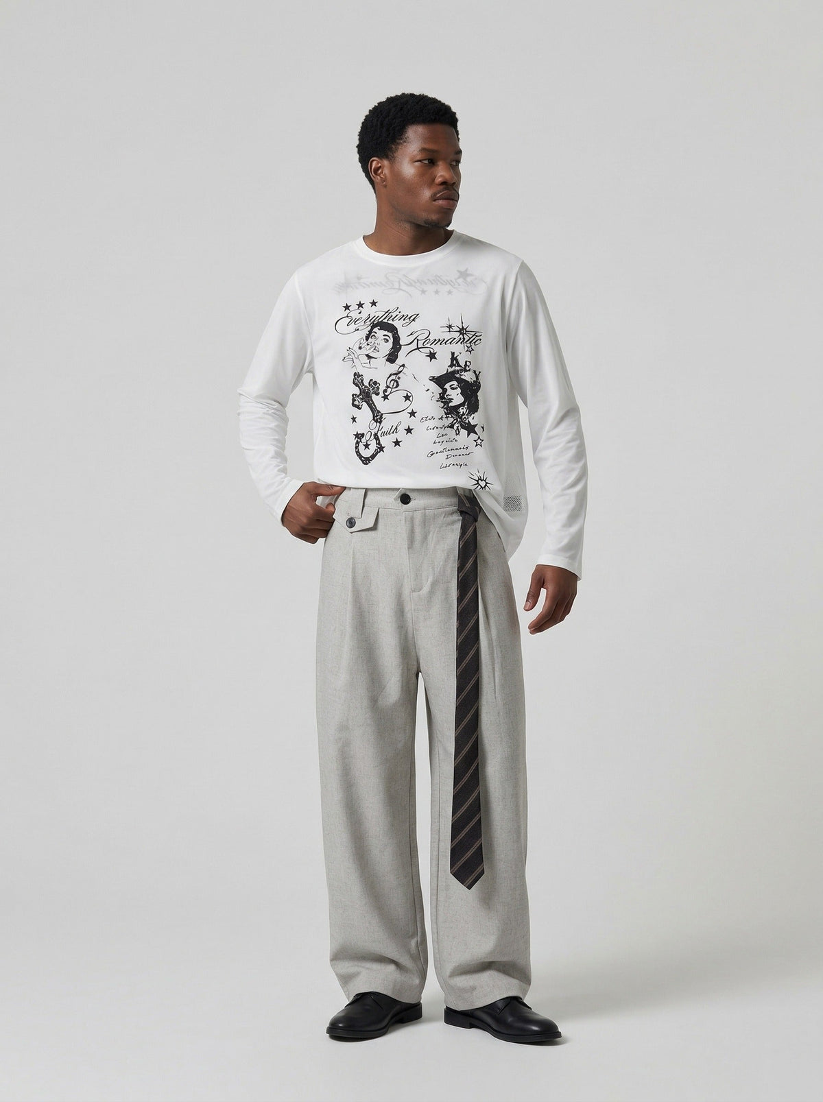 DAXUEN Graphic long sleeve t-shirt with text and designs — model photo