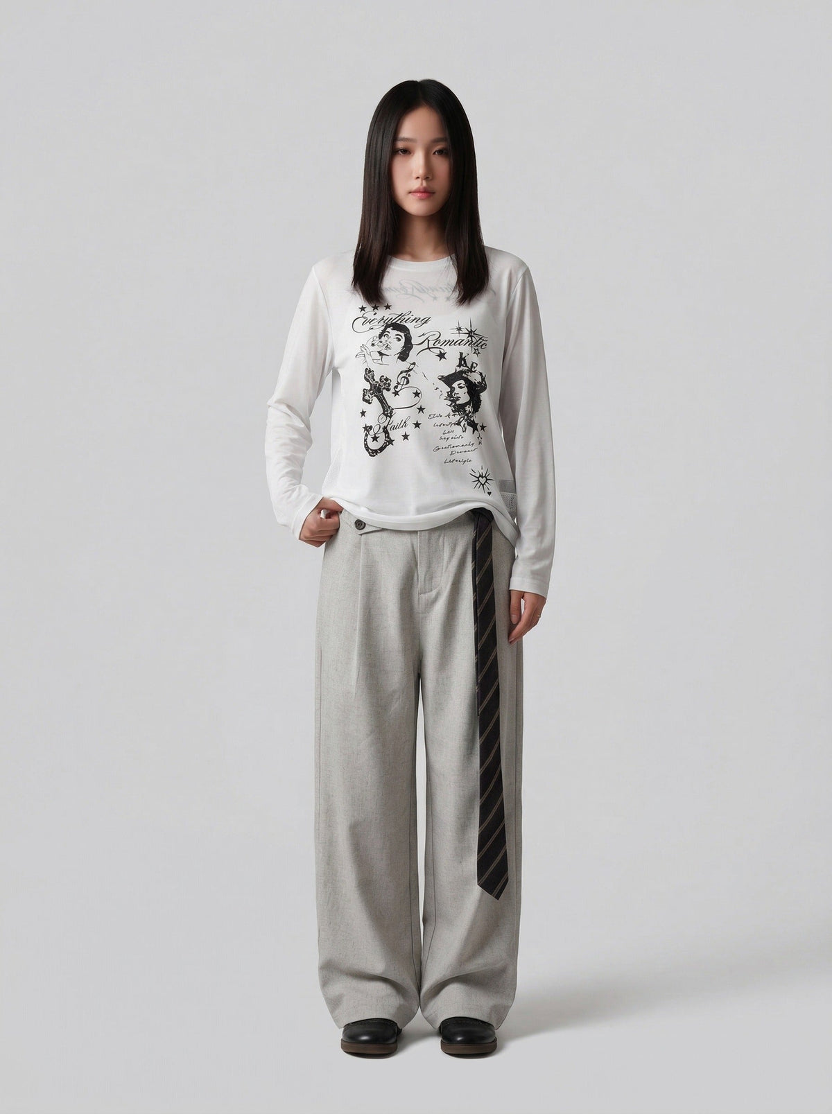 DAXUEN Graphic long sleeve t-shirt with text and designs — model photo