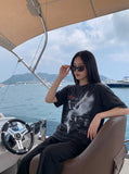 DAXUEN faded black winged angel graphic t-shirt — model photo