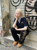 DAXUEN Faux-layered short-sleeved T-shirt with cartoon dog embroidery — model photo