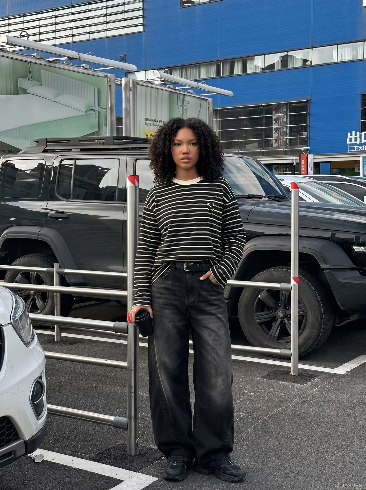 DAXUEN black oversized striped top with geometric embroidery — model photo