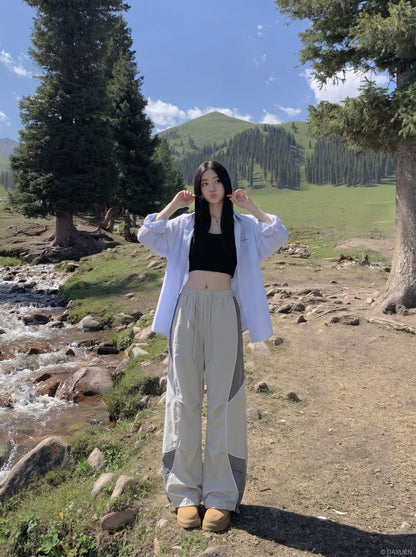 DAXUEN Wide-leg track pants with geometric color-blocked panels — model photo