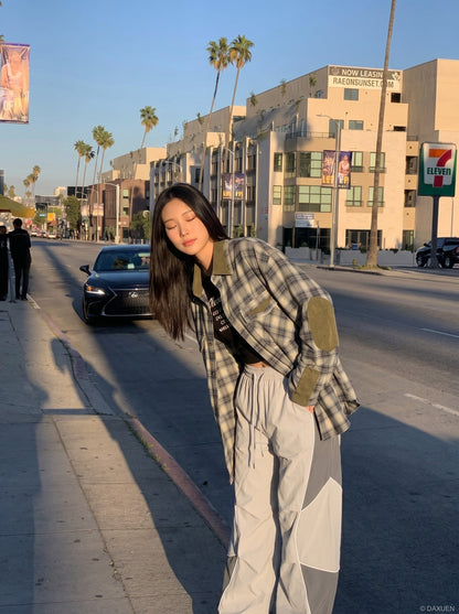 DAXUEN Wide-leg track pants with geometric color-blocked panels — model photo