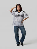DAXUEN Distressed V-neck short sleeve top with graphic print — model photo