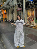 DAXUEN Distressed V-neck short sleeve top with graphic print — model photo