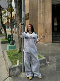 DAXUEN Distressed V-neck short sleeve top with graphic print — model photo