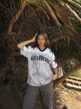 DAXUEN Distressed V-neck short sleeve top with graphic print — model photo