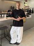 DAXUEN Glitchy text graphic short-sleeved T-shirt — model photo