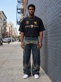 DAXUEN black oversized gold-embroidered shield and polo graphic t-shirt — model photo