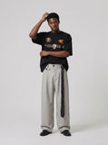 DAXUEN black oversized gold-embroidered shield and polo graphic t-shirt — model photo