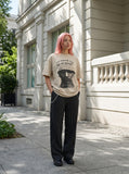 DAXUEN black oversized gold-embroidered shield graphic tee — model photo