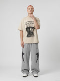 DAXUEN black oversized gold-embroidered shield graphic tee — model photo