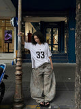 DAXUEN Gothic emblem V-neck T-shirt with printed graphics — model photo