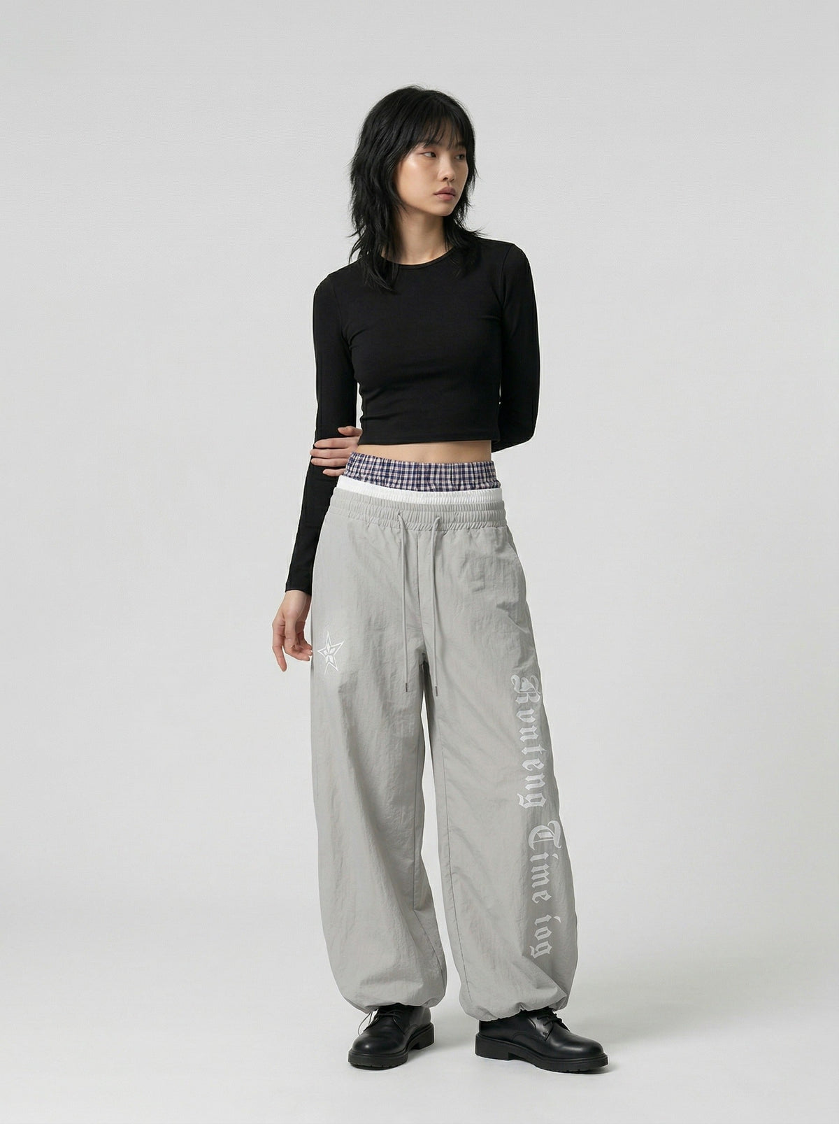 DAXUEN Gothic graphic wide-leg pants with multi-layered waistband — model photo