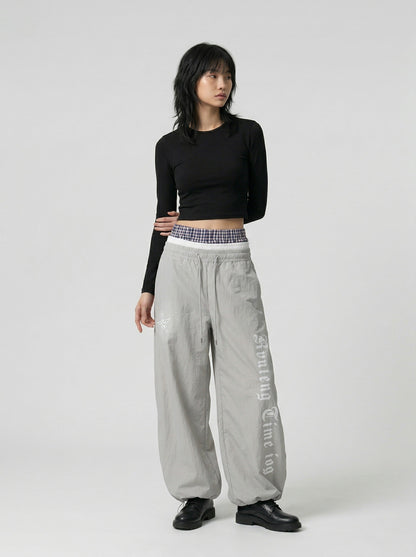 DAXUEN Gothic graphic wide-leg pants with multi-layered waistband — model photo