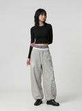 DAXUEN Gothic graphic wide-leg pants with multi-layered waistband — model photo