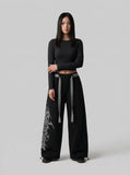 DAXUEN Wide-leg sweatpants with gothic graphic — model photo