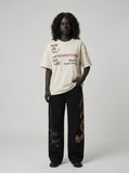 DAXUEN Graffiti print crewneck t-shirt in beige and black — model photo