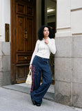 DAXUEN grey and black wide-leg sweatpants with bold cross graphic — model photo
