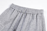 DAXUEN grey and black wide-leg sweatpants with bold cross graphic