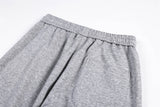 DAXUEN grey and black wide-leg sweatpants with bold cross graphic