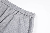 DAXUEN grey and black wide-leg sweatpants with bold cross graphic