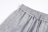 DAXUEN grey and black wide-leg sweatpants with bold cross graphic