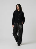 DAXUEN Graphic wide-leg trousers in black and mocha — model photo